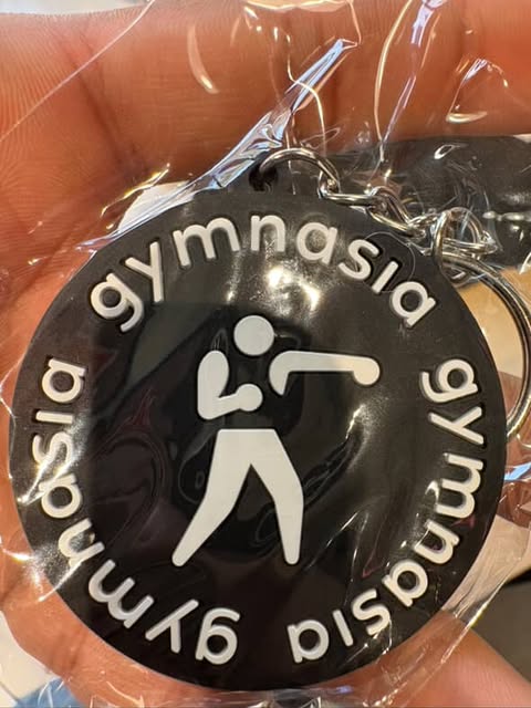 Gymnasia martial arts keychain featuring combat sports design front view
