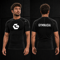 Adult wearing the branded Gymnasia short-sleeve rashguard, front and back