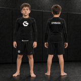 Child wearing the branded Gymnasia long-sleeve rashguard with shorts, front and back