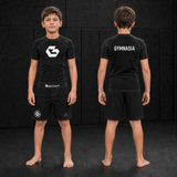 Child wearing the branded Gymnasia short-sleeve rashguard with shorts, front and back