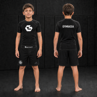 Child wearing the branded Gymnasia short-sleeve rashguard with shorts, front and back