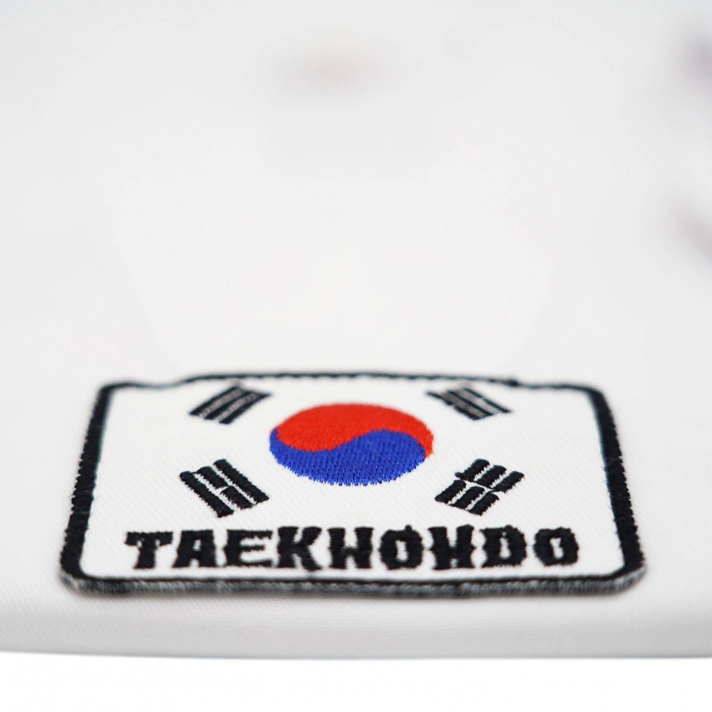 Close up of Fight Art logo on kids taekwondo dobok chest